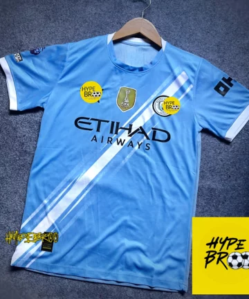 Manchester City 2025-26 home jersey front view laid on carpet with hanger