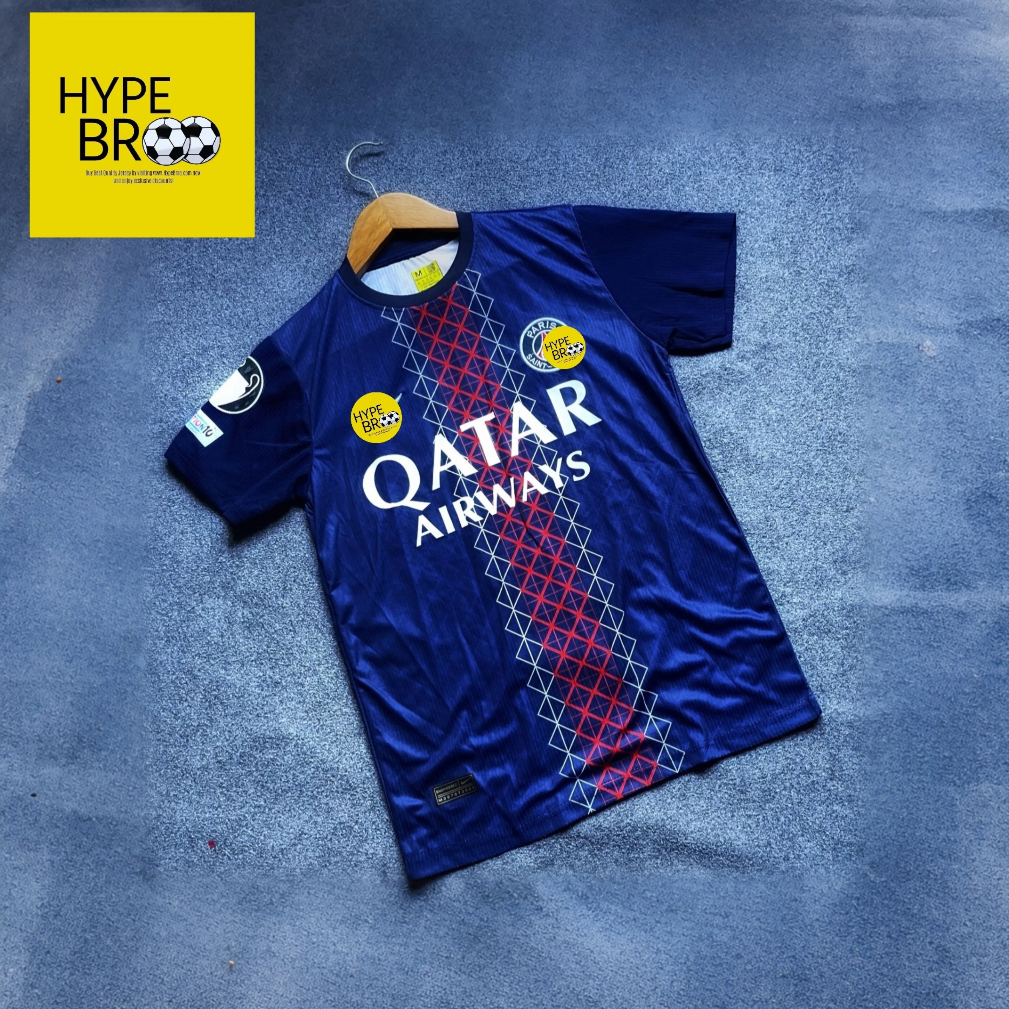 PSG 2025-26 home jersey front view laid on carpet with hanger