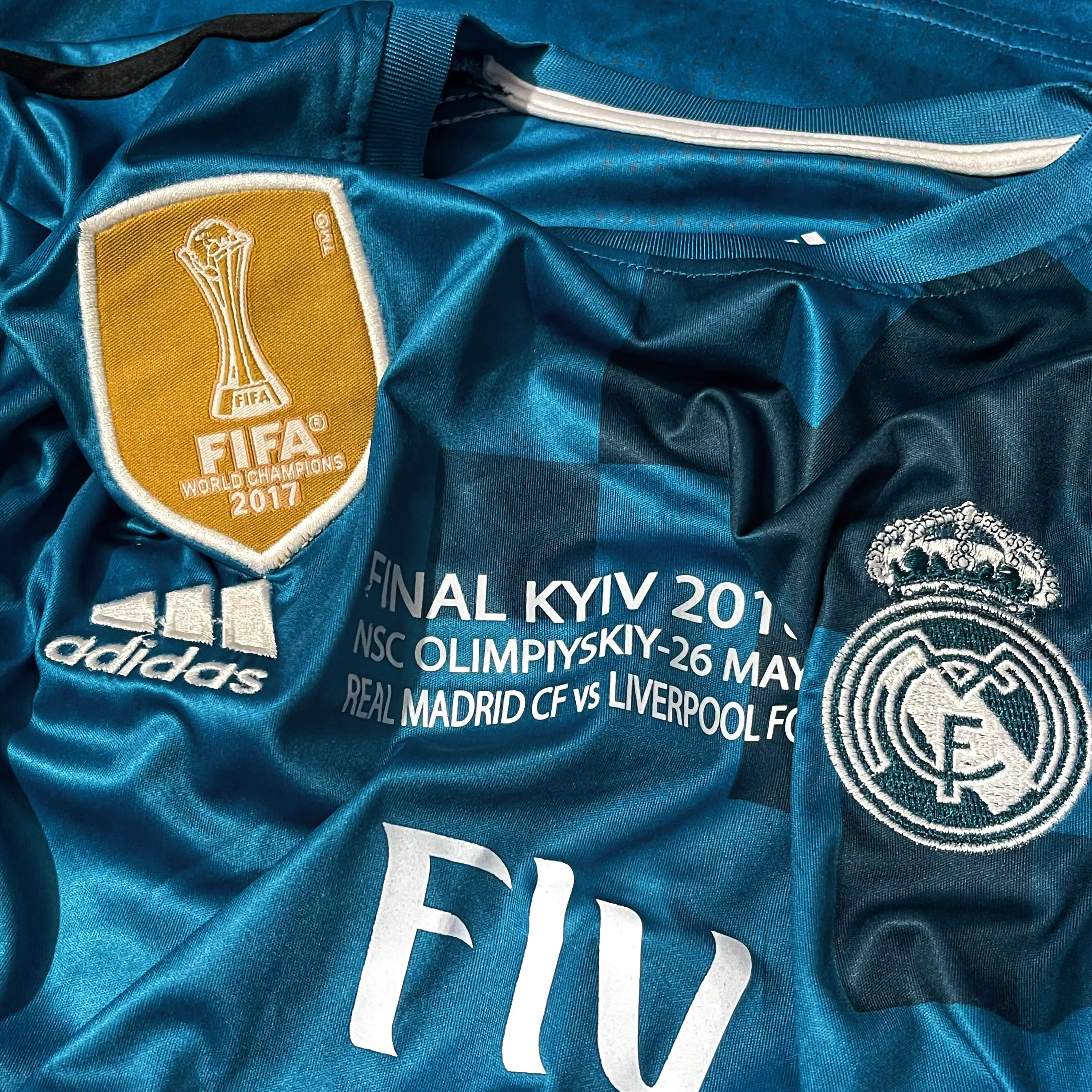 Close-up of Real Madrid crest and Adidas logo on 2017-18 third jersey
